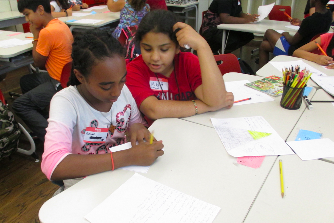 Two local students work together at an 826DC In-School Writing, Editing, and Publishing workshop