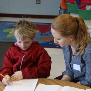 An 826DC volunteer supports a student