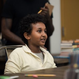 An AWL student smiles in the 826DC writing center.